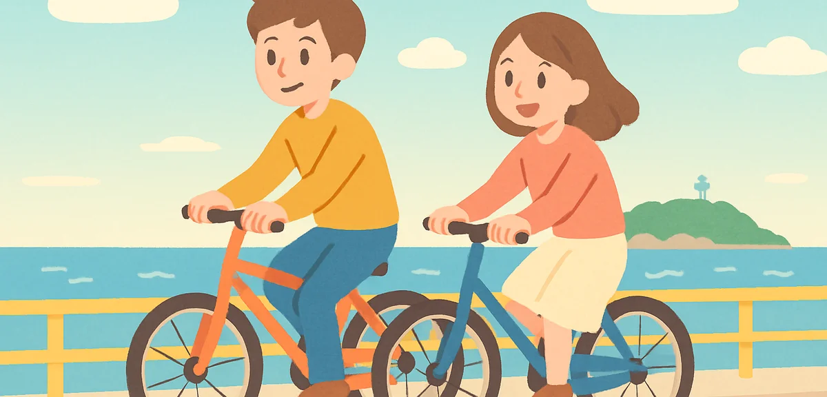 A couple riding bicycles along a coastal road near Enoshima with ocean view during Golden Week, rela