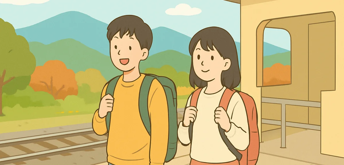 Two young Japanese university students with backpacks waiting on a rural train platform in early aut